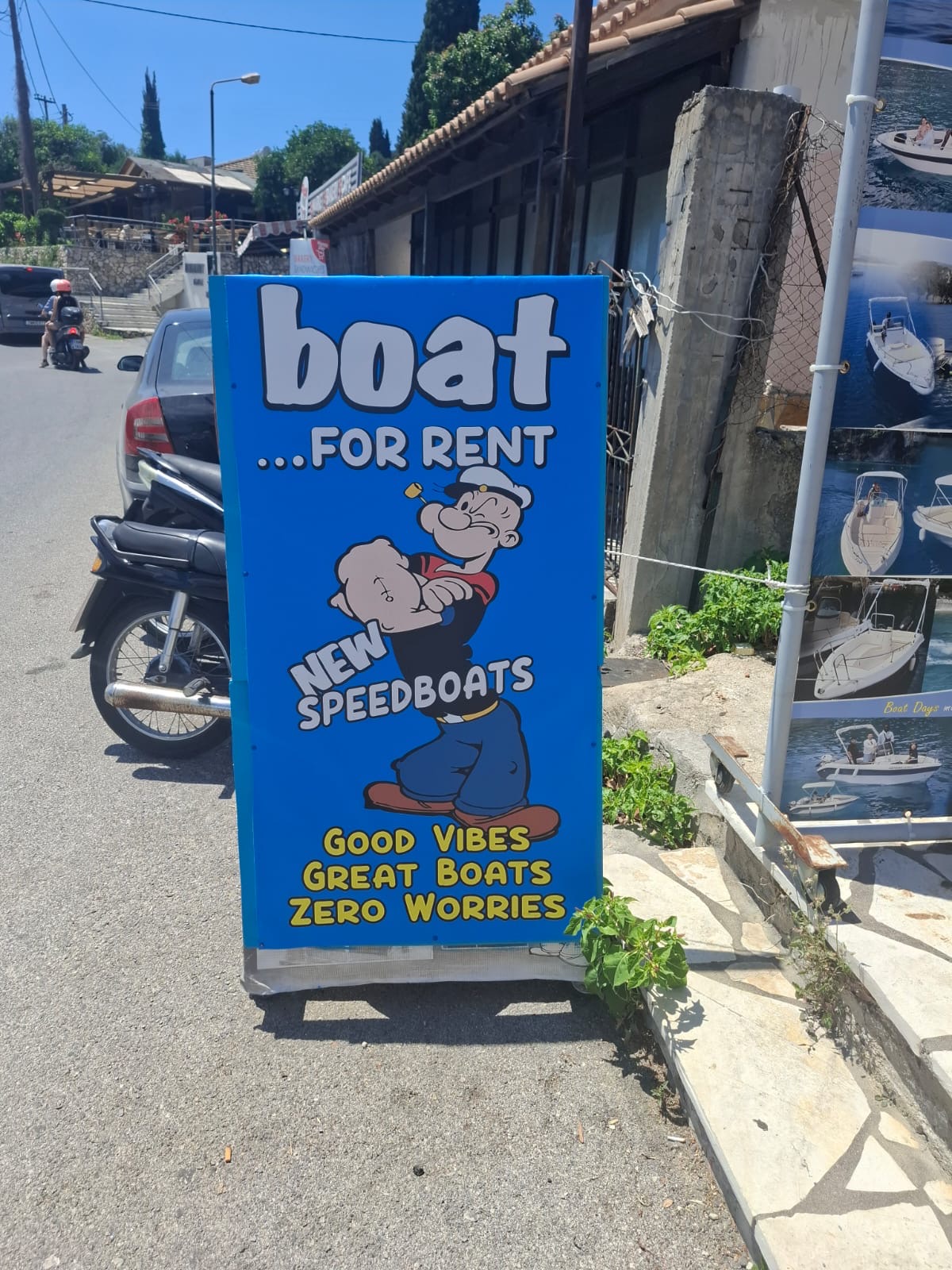 Blue 'Boat for Rent — Popeye' sign next to our office